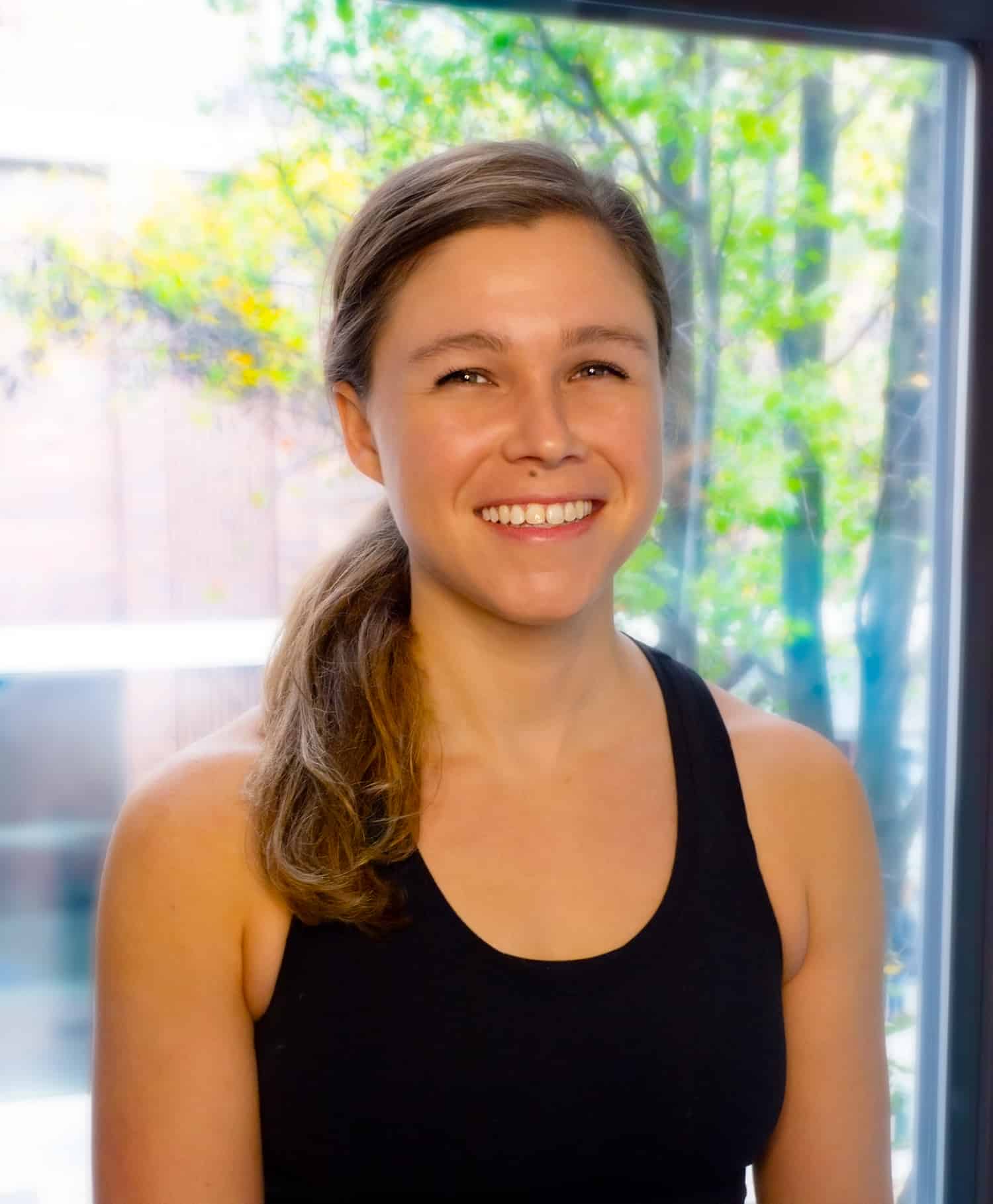 Stefanie Doolittle Portrait of Pilates Instructor Stefanie Doolittle in front of a window at Streamline Pilates