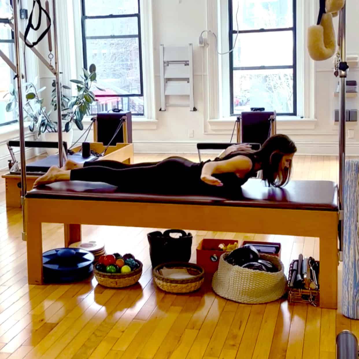 Video still of Charlotte performing an exercise called the Breaststroke.